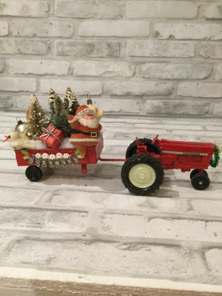 Red tractor and trailer filled with antique Christmas decorations and ornaments picture