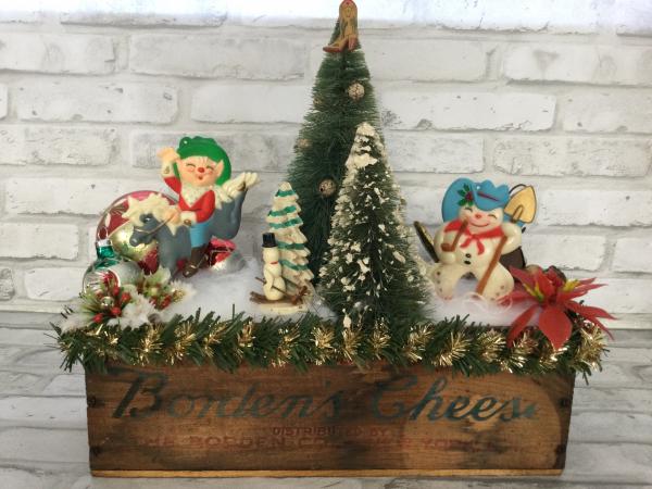 Antique Borden’s cheese box filled with antique Christmas decorations