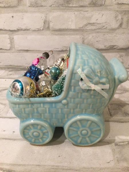 Antique baby carriage filled with antique decorations. picture