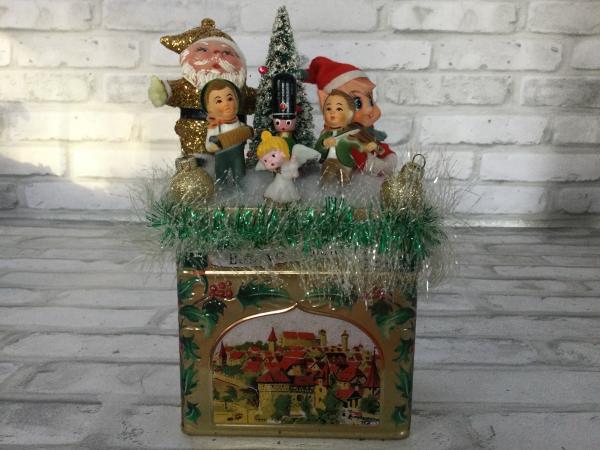 Vintage music box tin filled with vintage and antique decorations