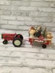 Red tractor and trailer filled with antique Christmas decorations and ornaments