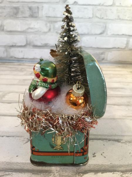 Antique tin filled with vintage Christmas decorations picture