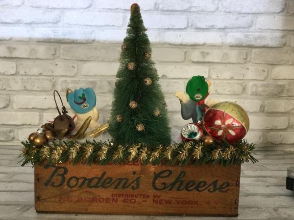 Antique Borden’s cheese box filled with antique Christmas decorations picture