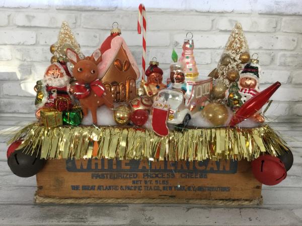 Antique cheese box filled with antique Christmas decorations