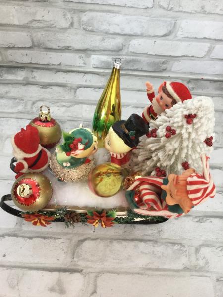 Sleigh filled with antique Christmas decorations. picture