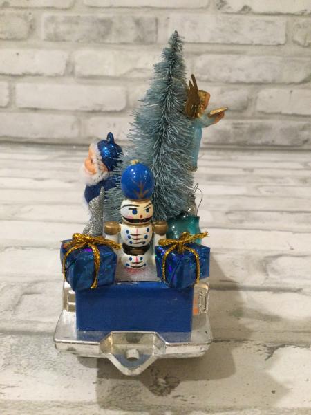 Vintage blue Tonka truck filled with antique Christmas decorations and ornaments. picture