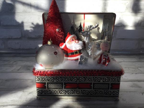 Antique Christmas tin filled with vintage Christmas decorations.