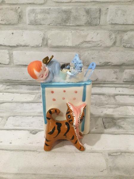 Antique tiger baby planter filled with antique decorations