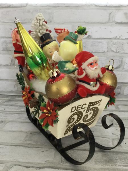 Sleigh filled with antique Christmas decorations.