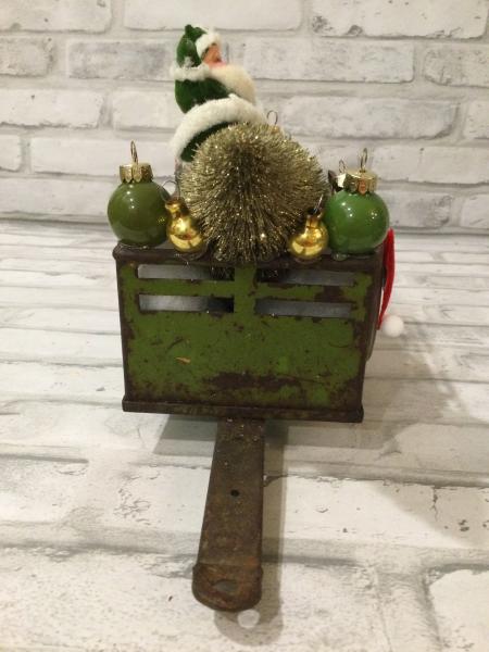 Antique green trailer filled with antique Christmas decorations and vintage ornaments