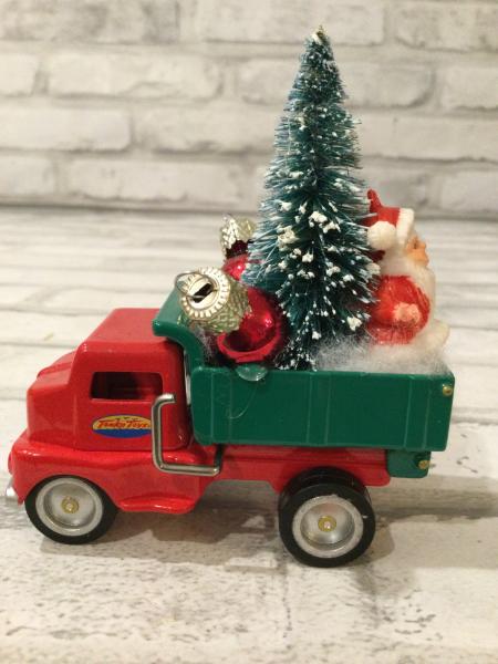 Vintage red and green dump truck  filled with vintage Christmas decorations