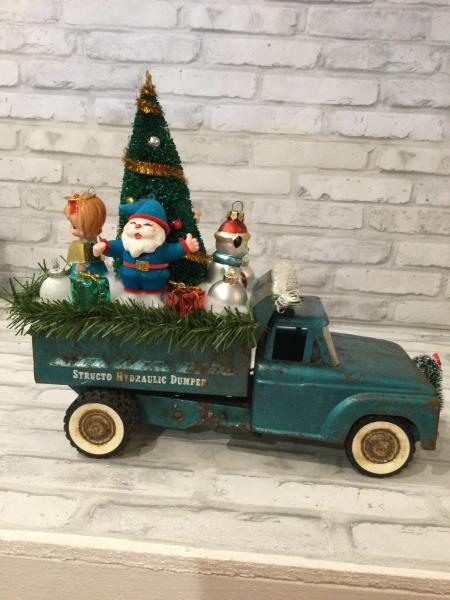 Antique teal dump truck filled with antique decorations