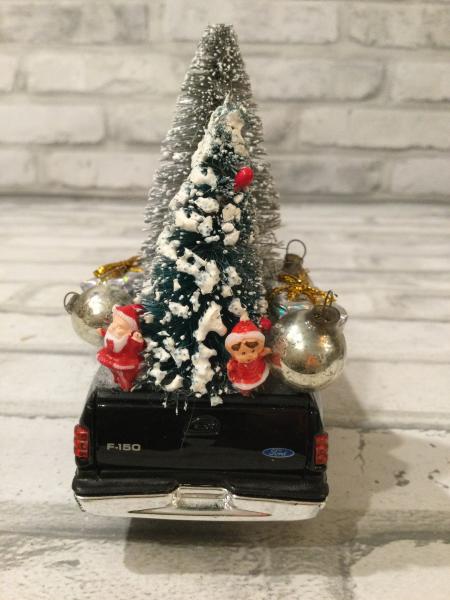 Black Ford truck filled with antique Christmas decorations picture