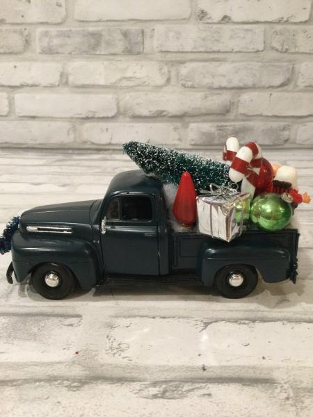 Dark green Ford truck with vintage decorations