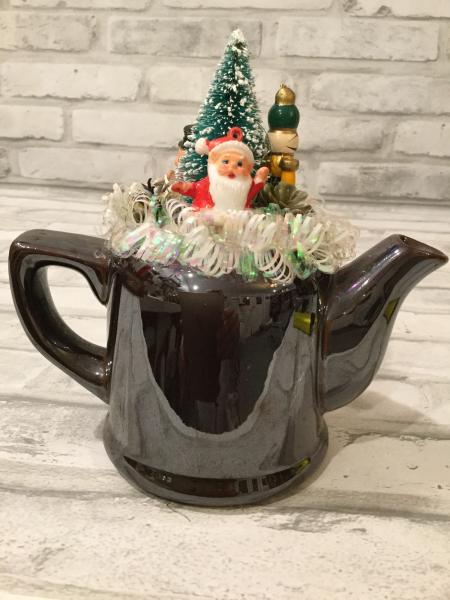 Brown tea pot with antique ornaments and vintage picture