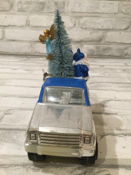 Vintage blue Tonka truck filled with antique Christmas decorations and ornaments. picture