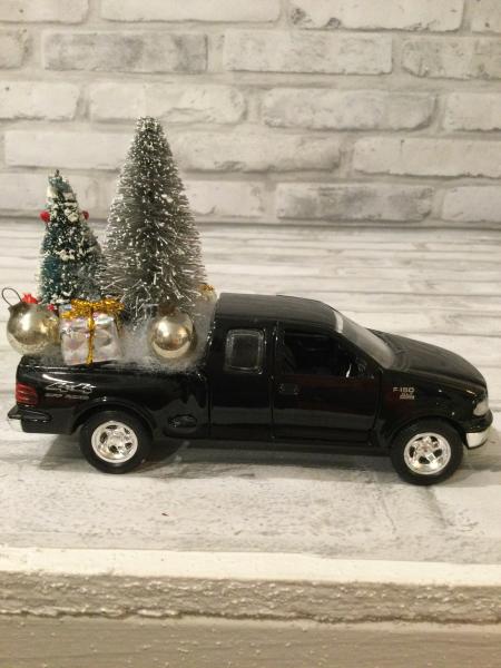 Black Ford truck filled with antique Christmas decorations picture