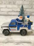 Vintage blue Tonka truck filled with antique Christmas decorations and ornaments.