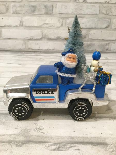 Vintage blue Tonka truck filled with antique Christmas decorations and ornaments. picture