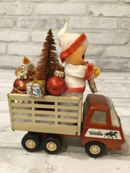 Vintage Tonka truck filled with antique Christmas decorations picture