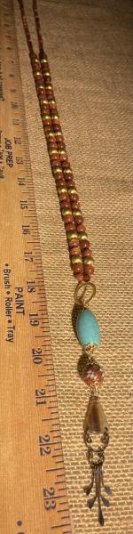 Long hand knotted necklace with goldstone picture