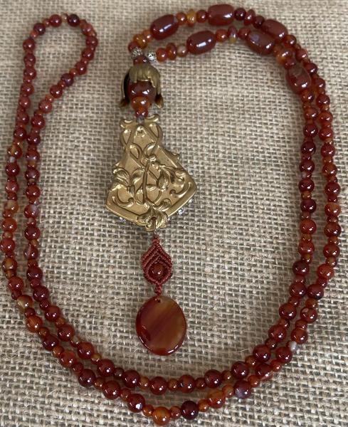 Long carnelian necklace with vintage brass picture