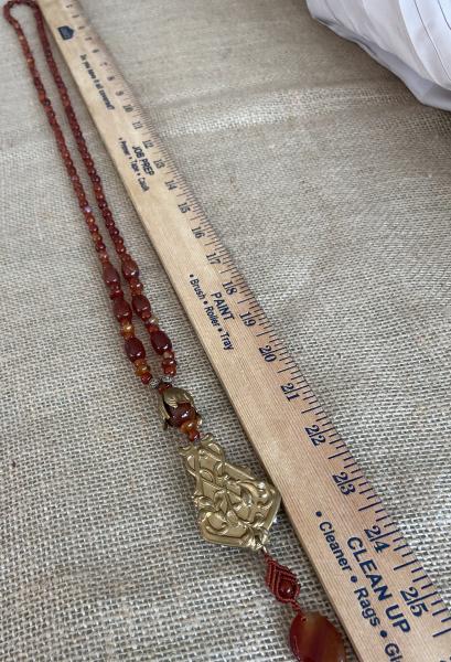 Long carnelian necklace with vintage brass picture