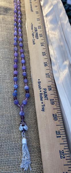 Long hand knotted necklace with purple frosted agate and crystal picture