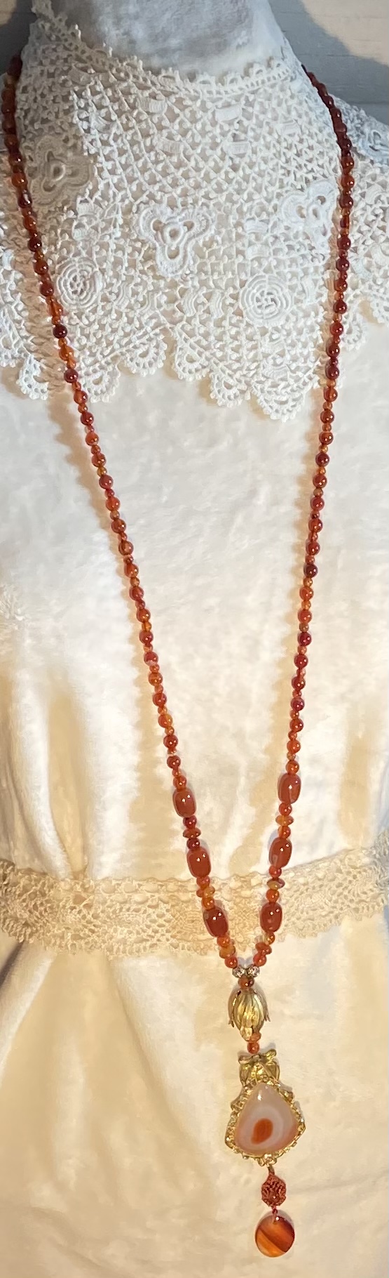 Long carnelian necklace with vintage brass picture