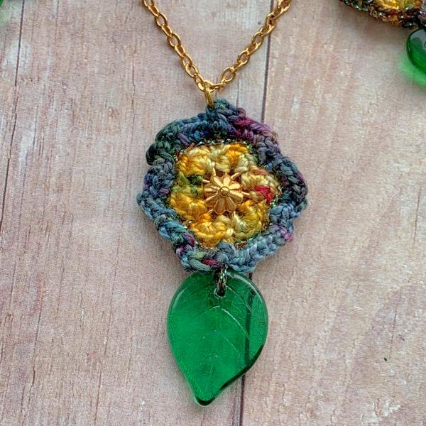 Golden Yellow Five Flowers Necklace - Mixed Media - Green Glass Leaves - Fiber - Gold Chain - Crochet - Adjustable Length 18 to 19 1/2" picture