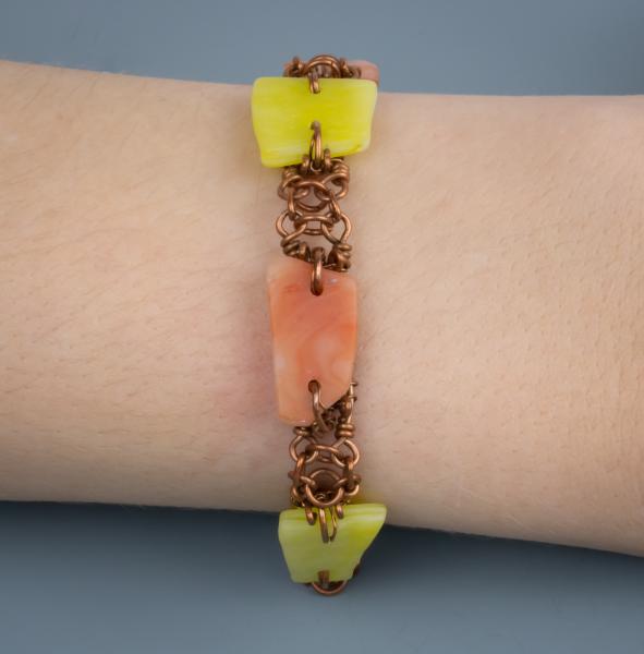 Yellow and orange tumbled glass and copper wire woven bracelet. picture