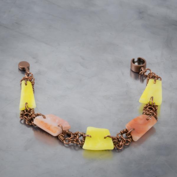Yellow and orange tumbled glass and copper wire woven bracelet.