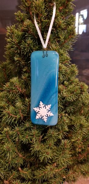 Large blue glass ornament with snowflake picture