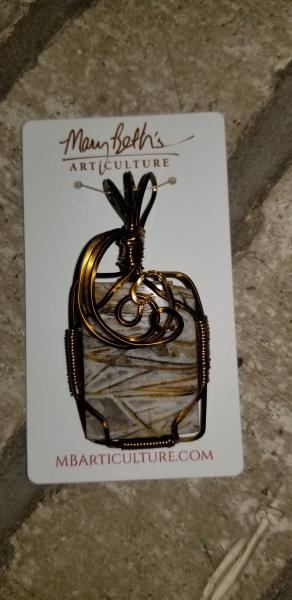 Brass wire wrapped fossil pendant picture