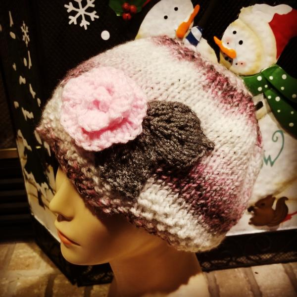 Knit pastel hat with a light pink rose picture