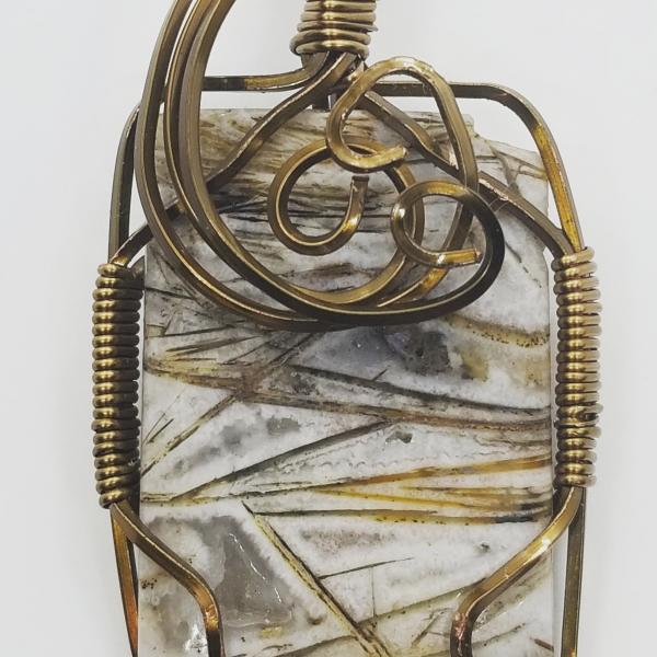 Brass wire wrapped fossil pendant picture