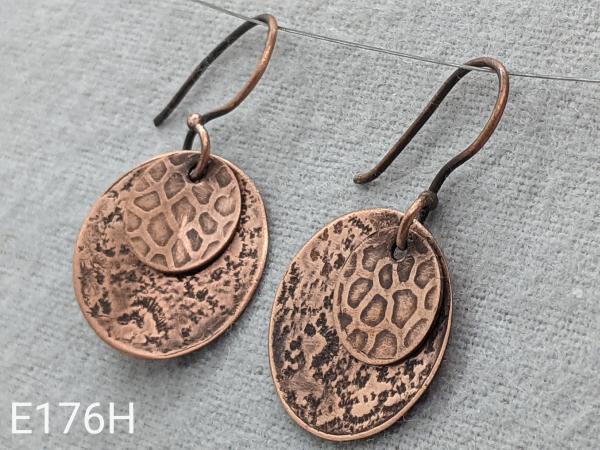 Textured two disk copper with patina