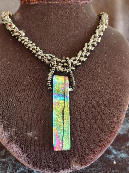 Dichroic pendant with beaded rope.