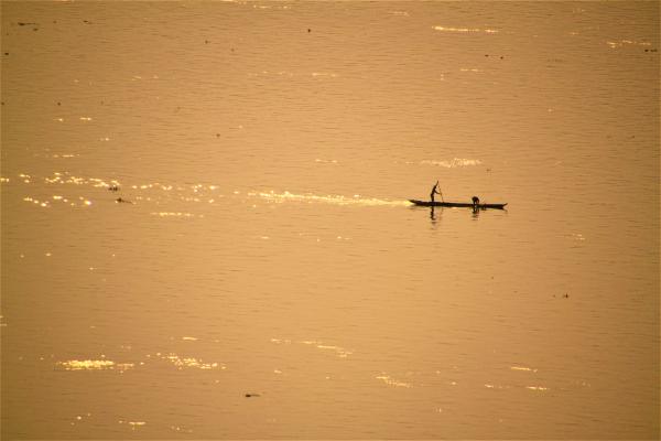 The Day is Done -- Congo River Fisherman Heading Home picture