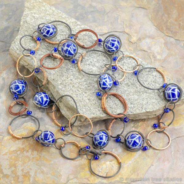 Copper-wrapped steel necklace with blue ceramic beads