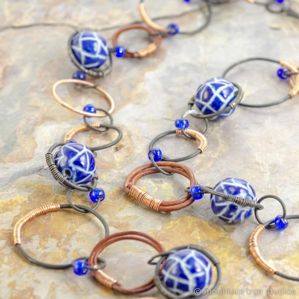 Copper-wrapped steel necklace with blue ceramic beads picture