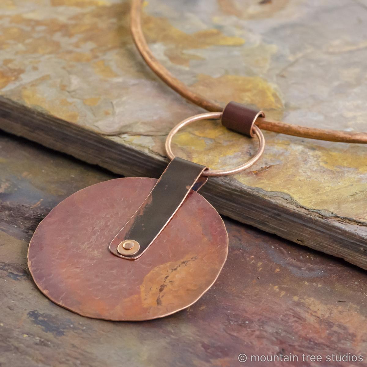 Large rustic disc pendant on torque necklace picture