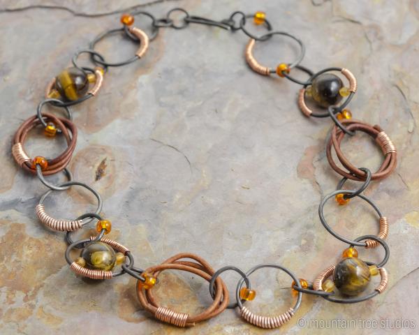 Wire-wrapped steel, leather and tigers-eye necklace picture