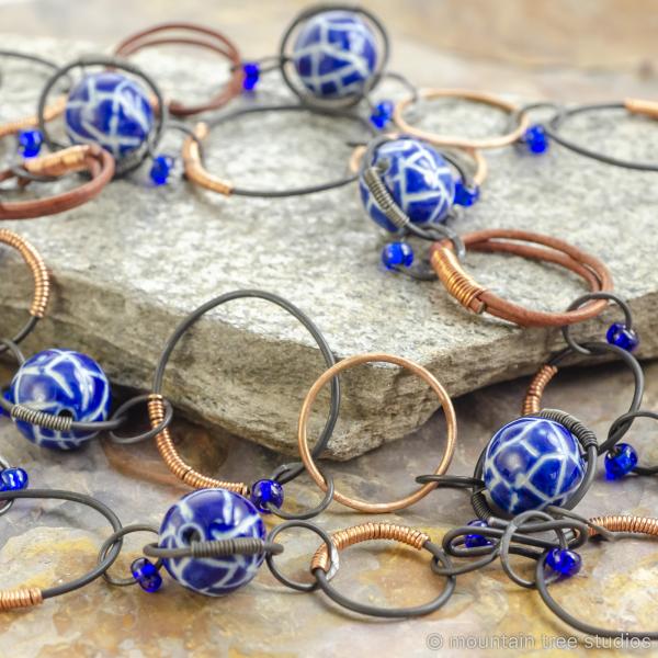 Copper-wrapped steel necklace with blue ceramic beads picture
