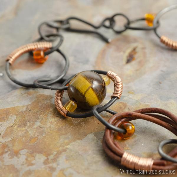 Wire-wrapped steel, leather and tigers-eye necklace picture