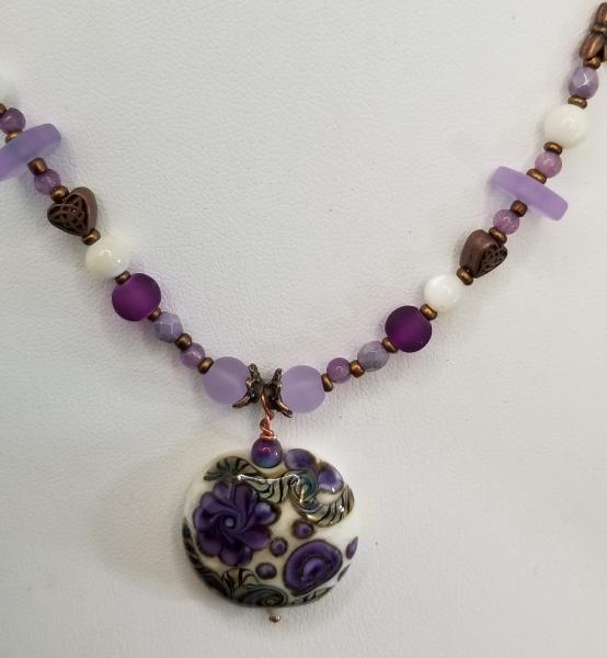 Purple Flowers in Ivory field round pendant