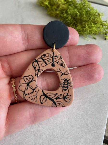 Hand Painted Nature Inspired Design on Dark Tan Rounded Triangle Dangles with Black Studs picture